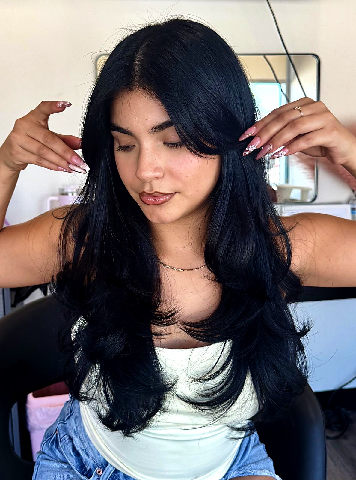 Client with long black layered hair at That's So Cee