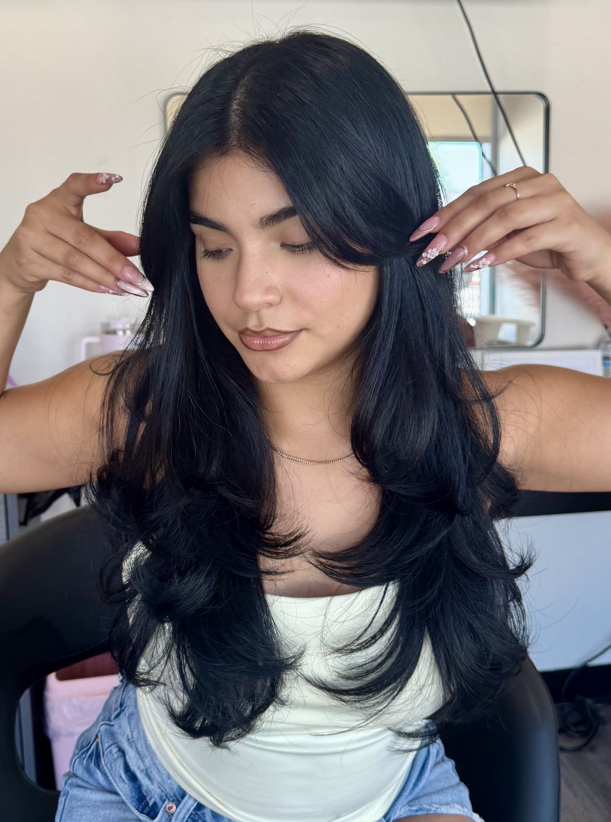 Client with long black layered hair at That's So Cee