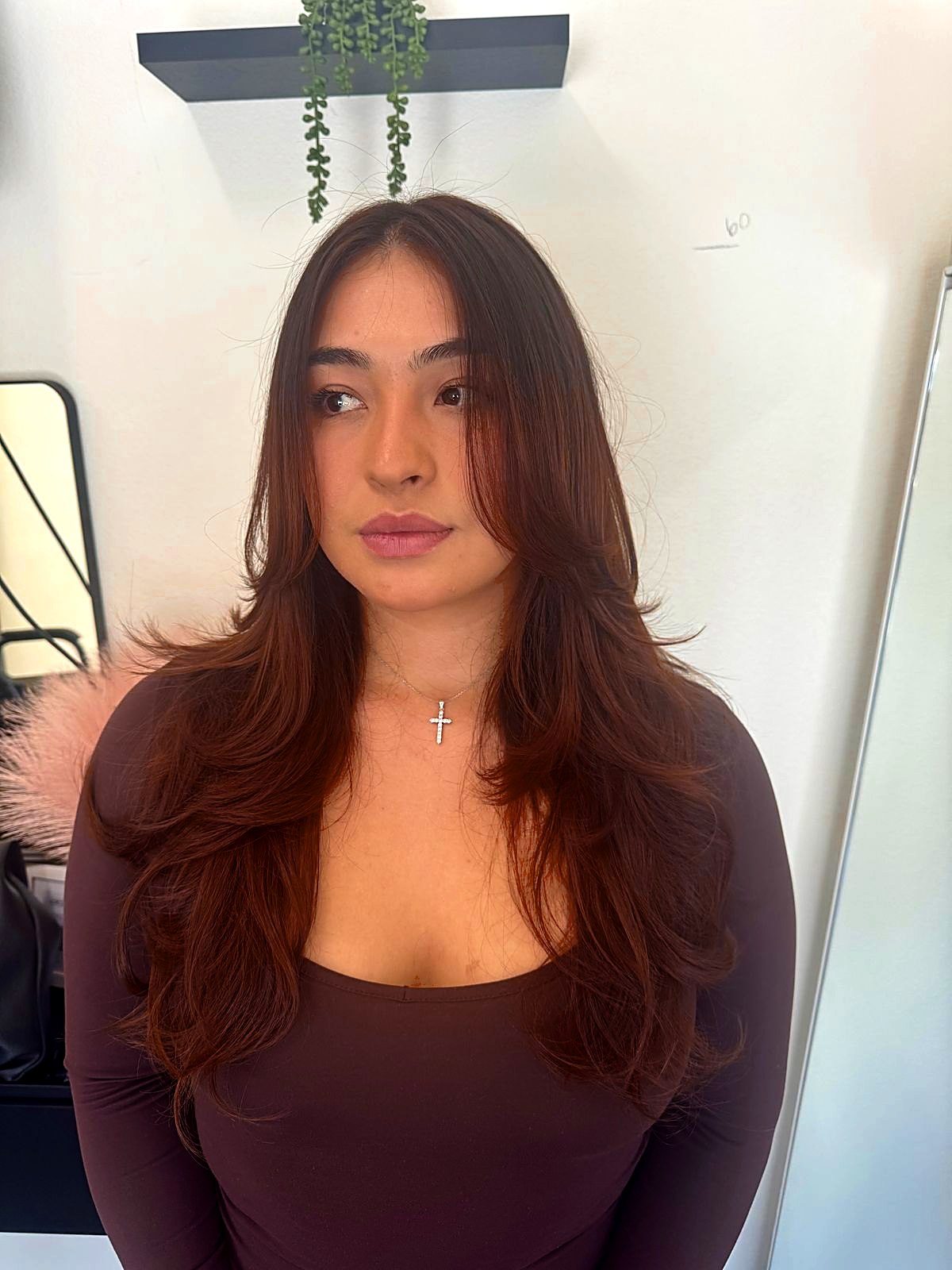 Client with long brown layered hair at That's So Cee salon in El Monte