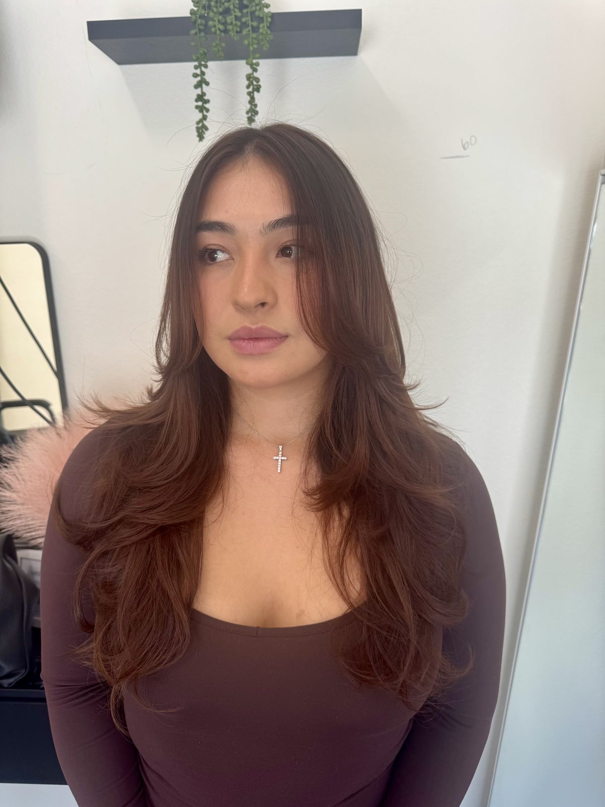 Client with long brown layered hair at That's So Cee salon in El Monte