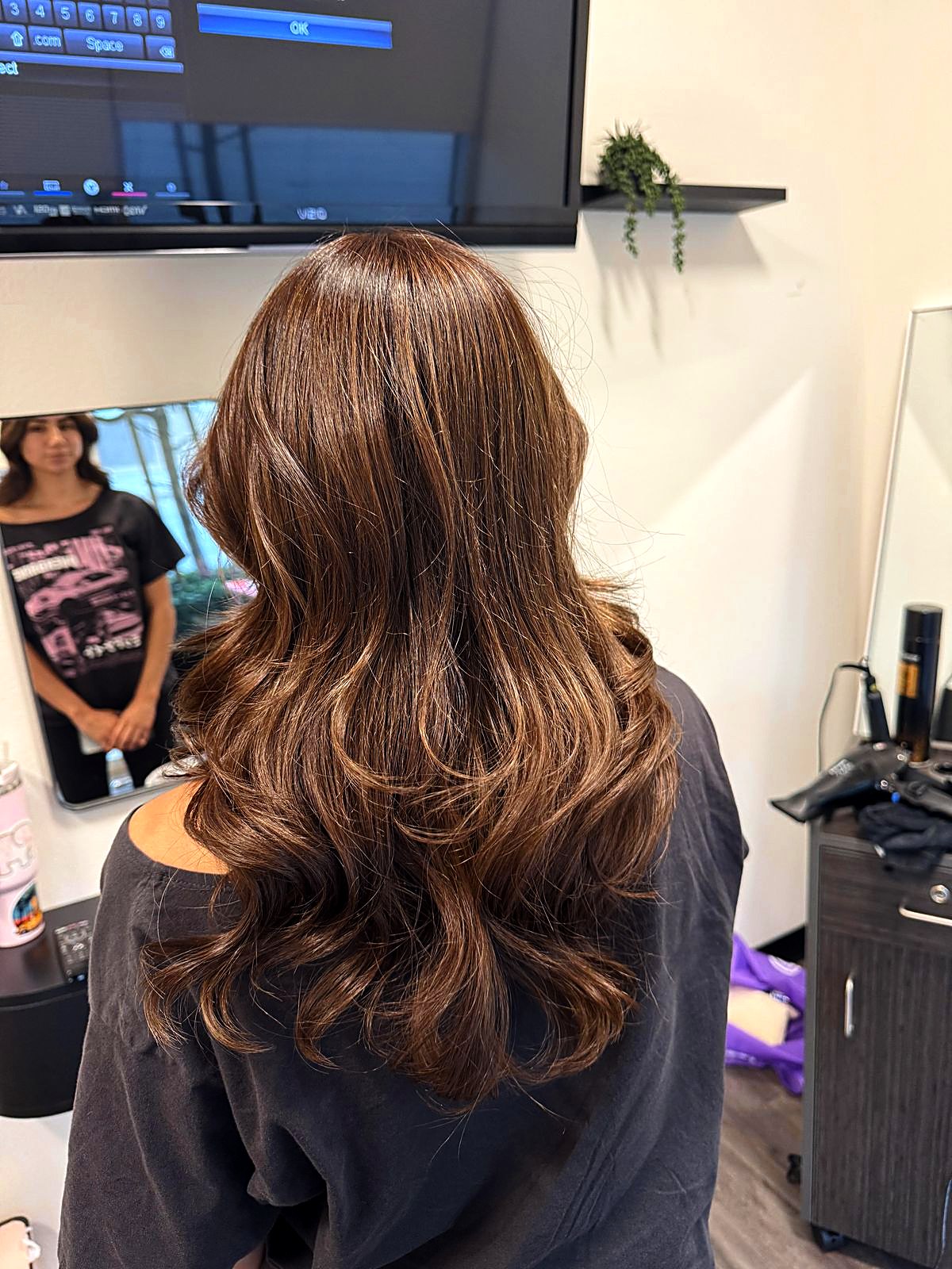 Light brown waves styled at the salon, back view