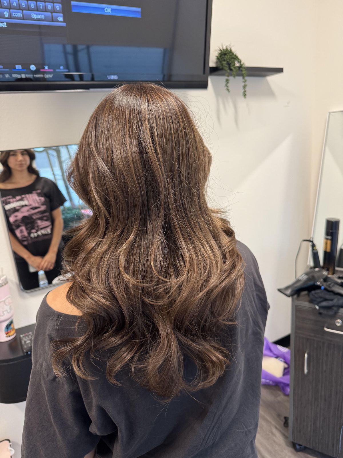 Light brown waves styled at the salon, back view